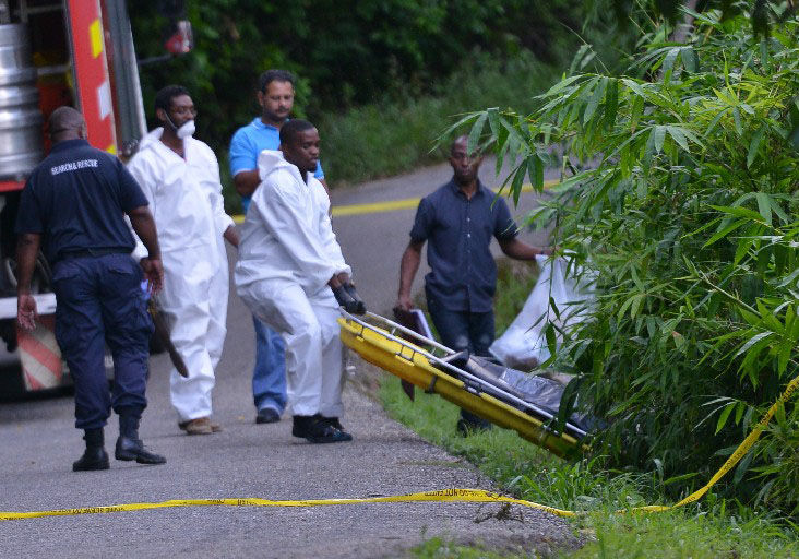 recovering body: Undertakers remove the body of Hermina Doughty,